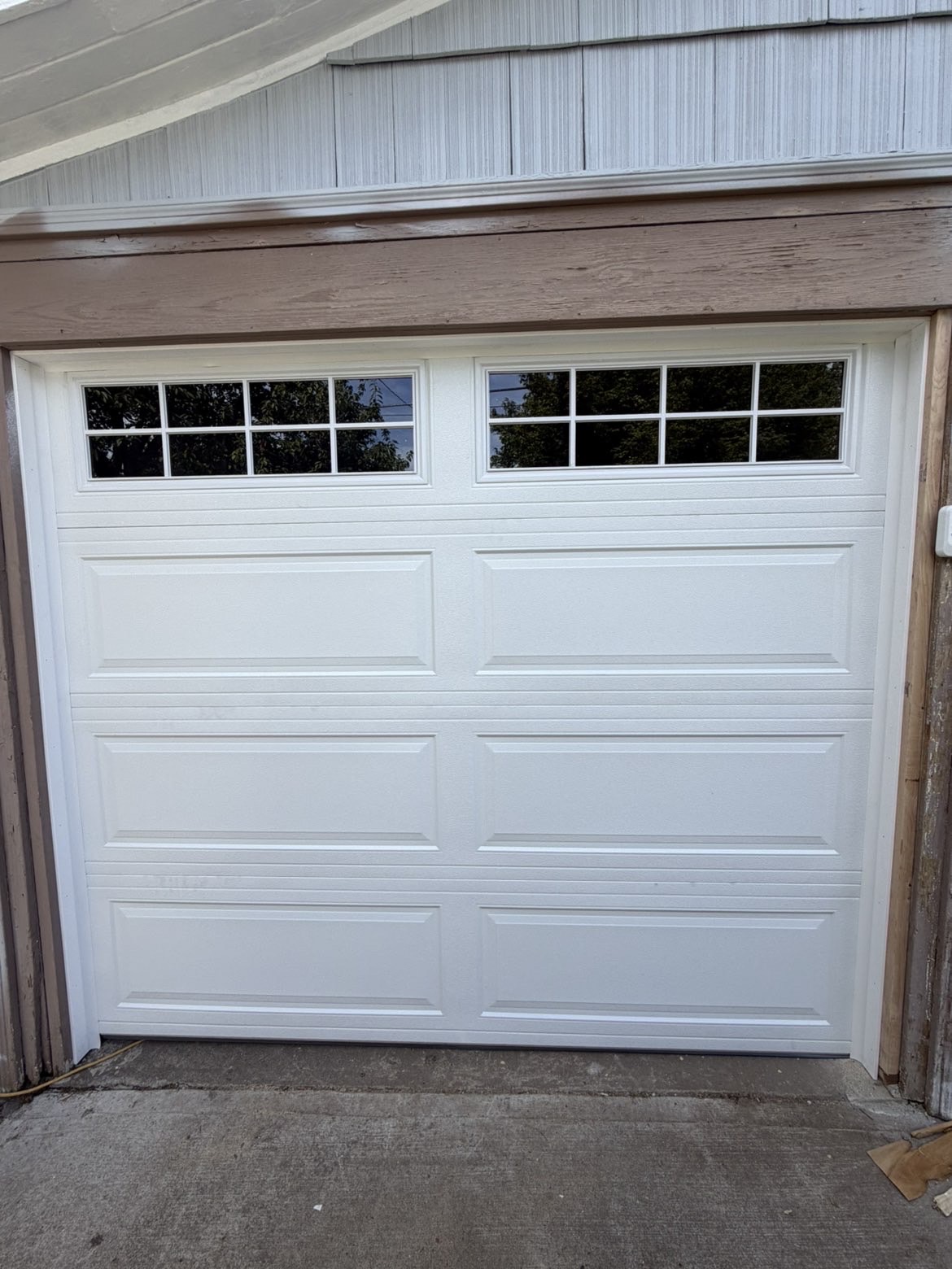 White raised-panel residential garage door with windows