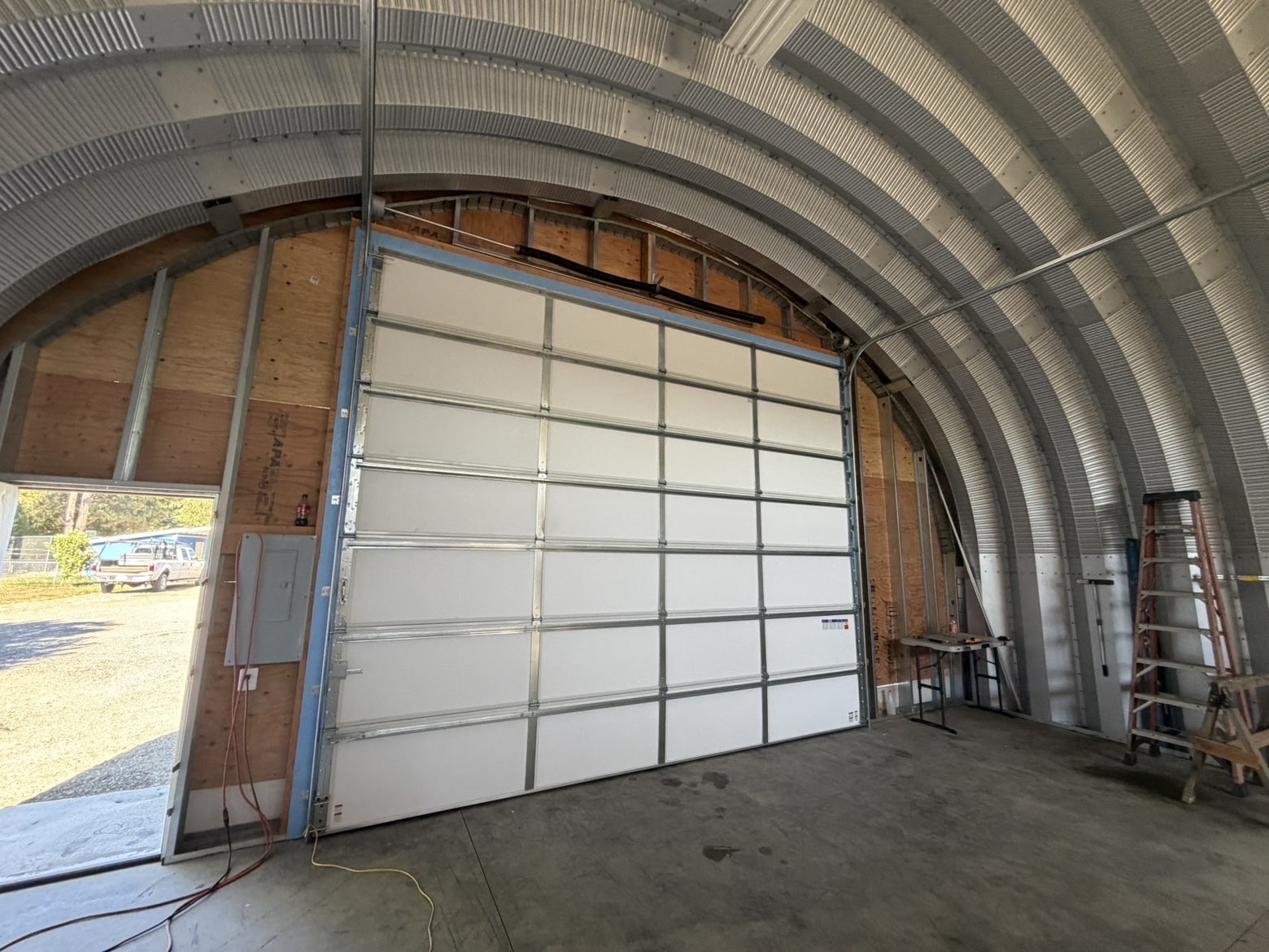 Technician oiling garage door hinges and rollers