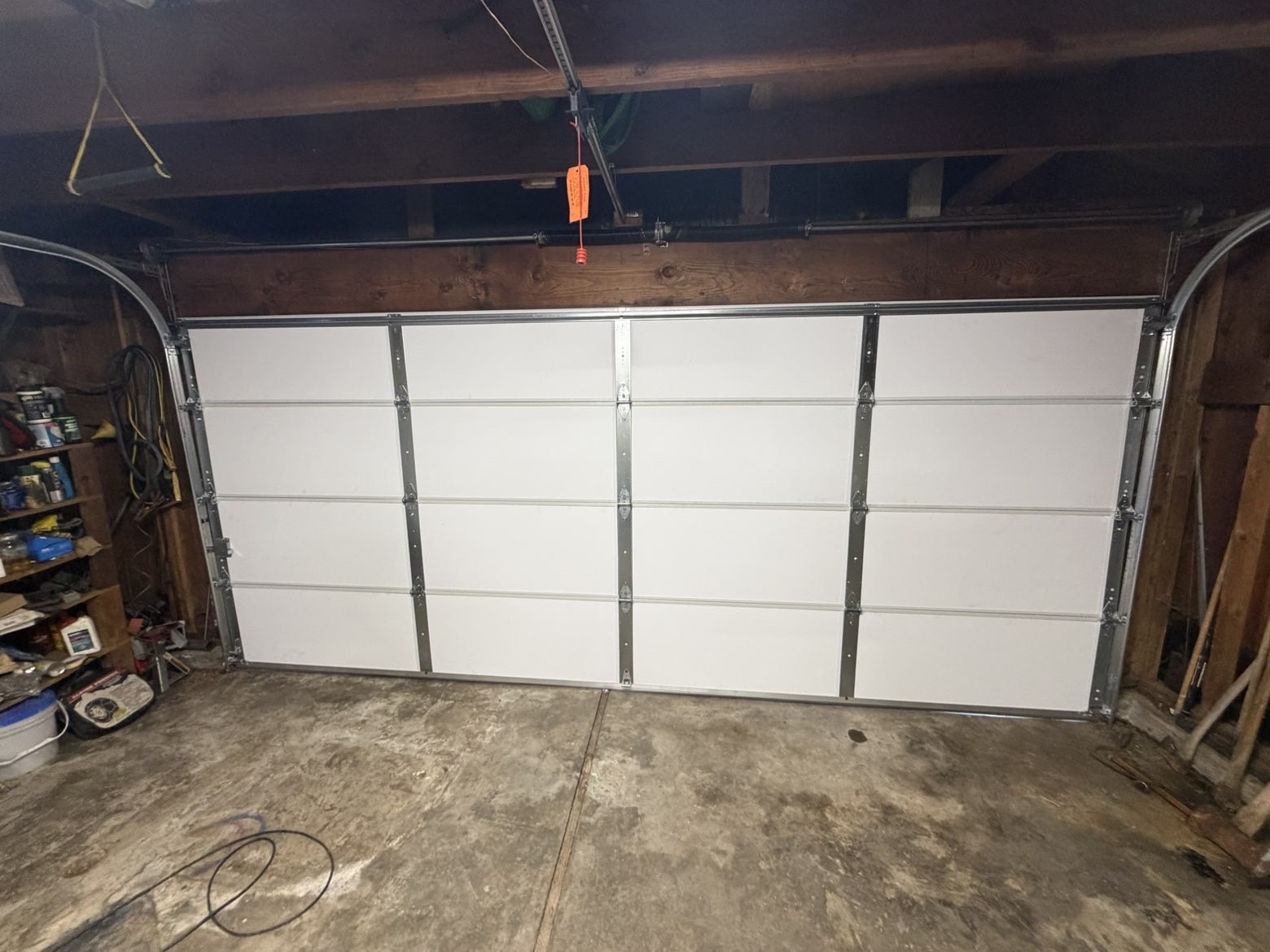 Interior of a newly installed white double garage door with opener